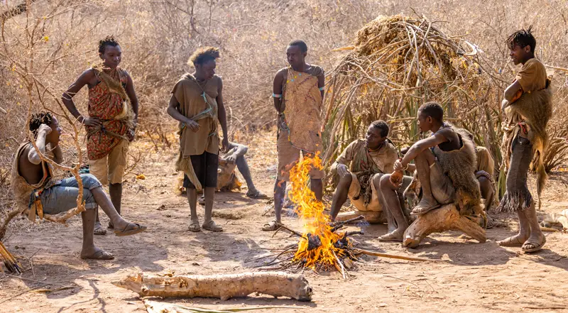 Hadzabe community members around a fire near Lake Eyasi