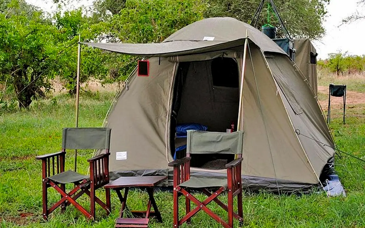 Safari tent pitched under acacia trees